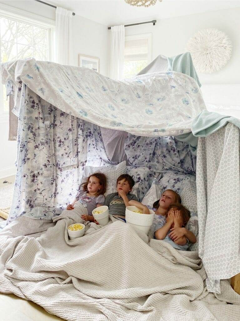 kids blanket fort eating popcorn