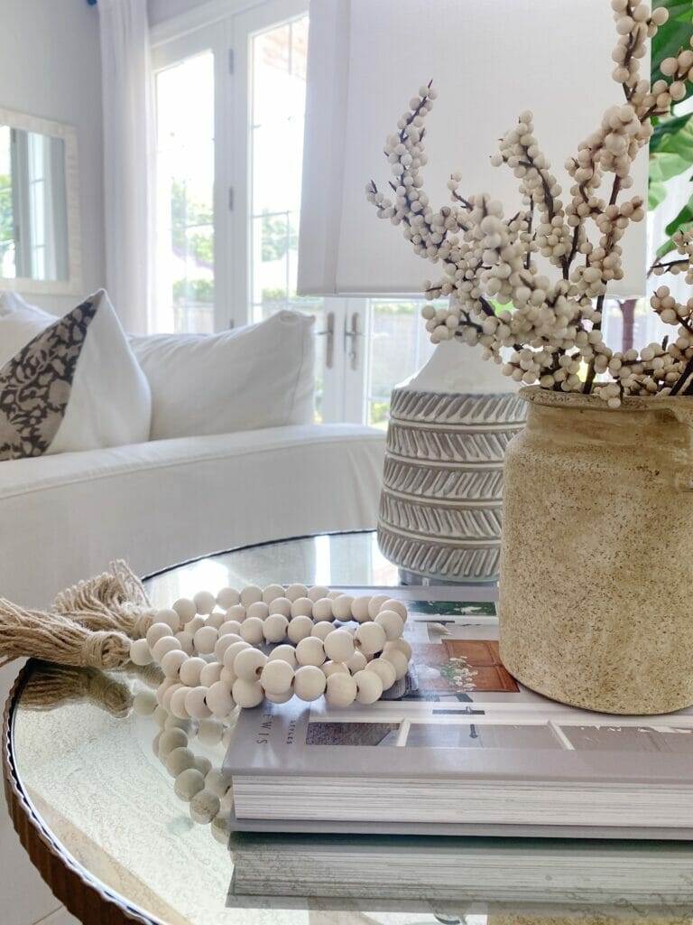 fall home decor features textured vase and lamp, wood beads and faux berry stems