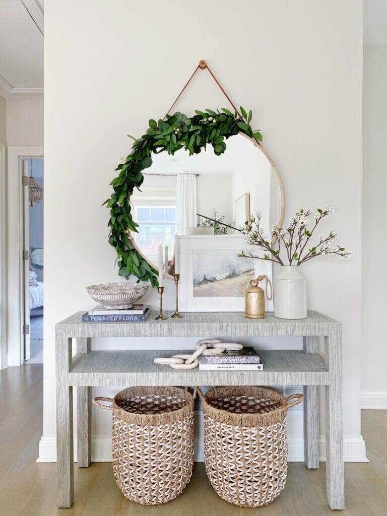 Serena & Lily Black console table Serena & Lily Black console table in fog, round mirror from west elm with garland detailing, and Christmas table styling